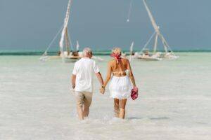 elderly couple enjoying a beach walk in zanzibar