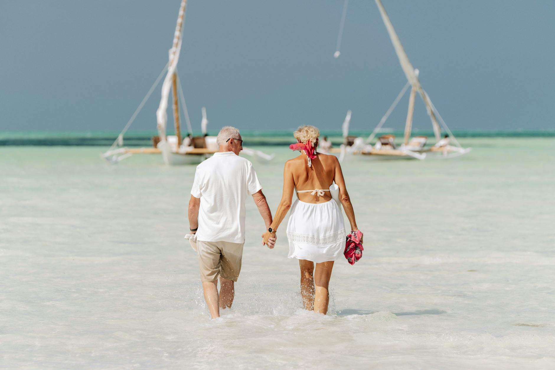 elderly couple enjoying a beach walk in zanzibar