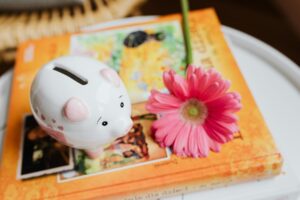 piggy bank beside a flower