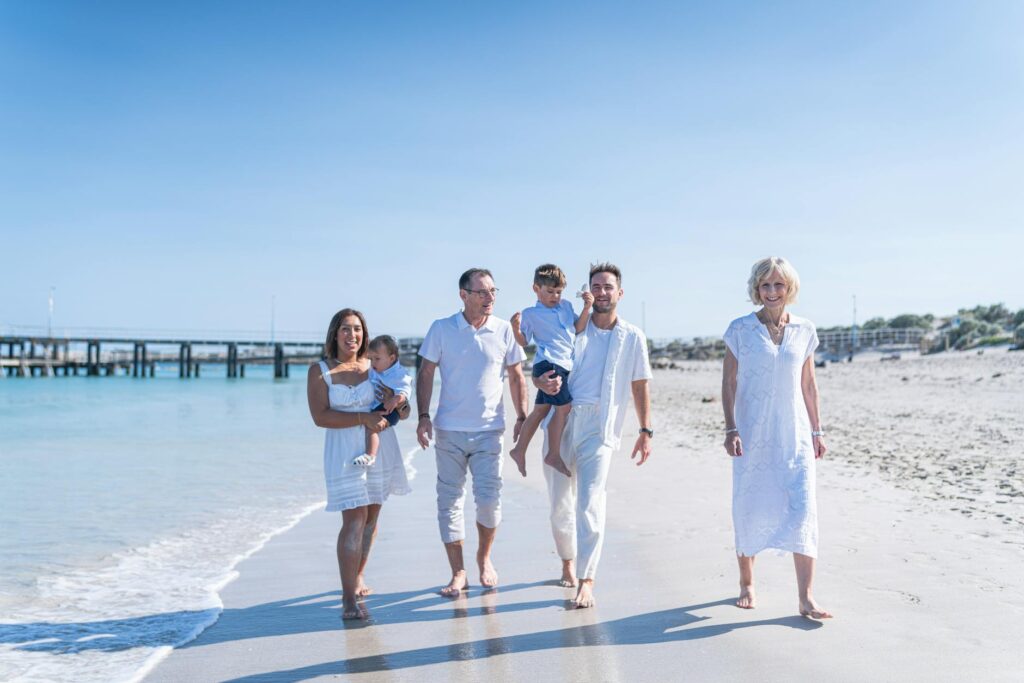 family walk on the beach during summer