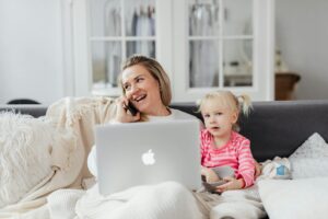 woman talking on phone on sofa with girl