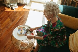 high angle shot of elderly woman looking at her vintage photos